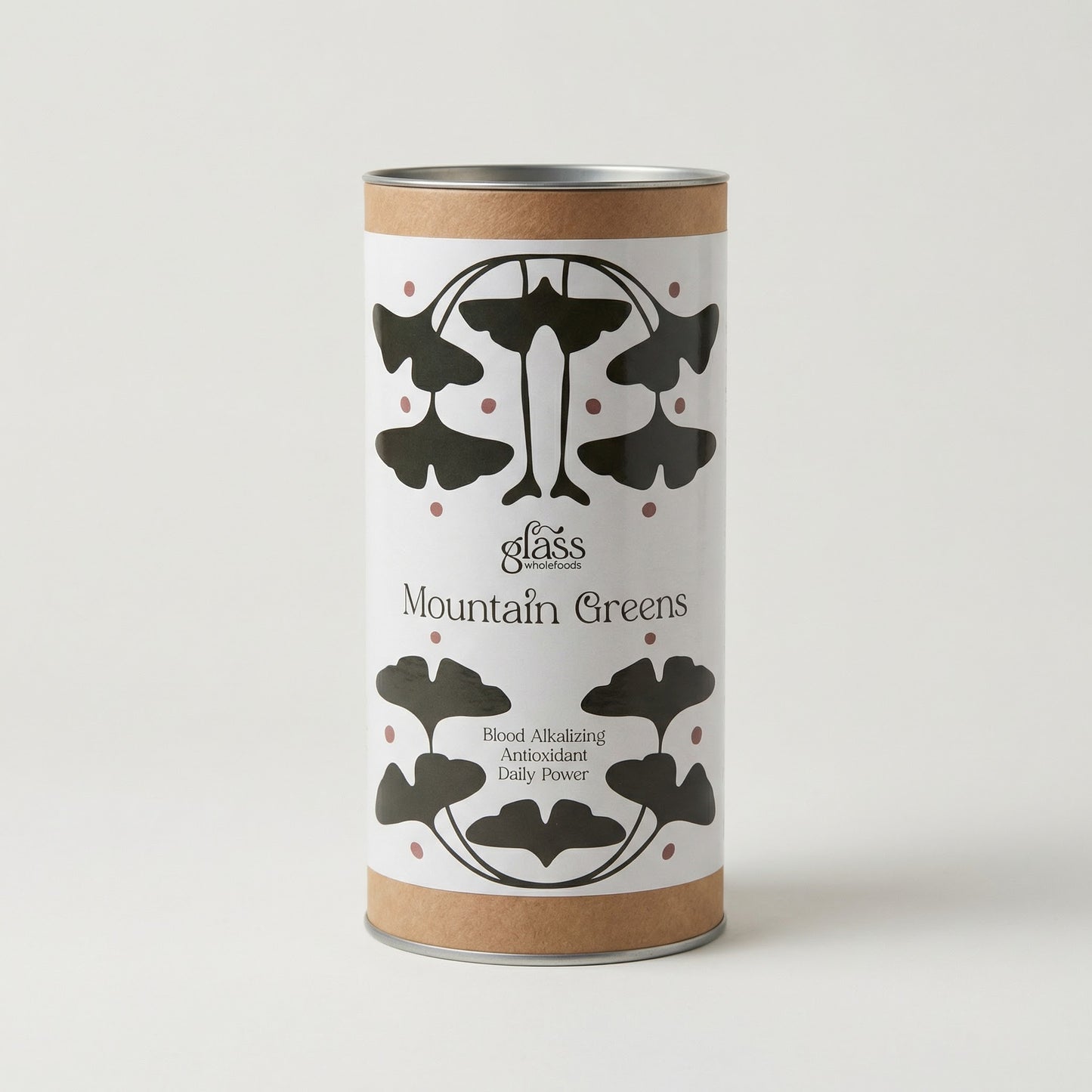 Glass Wholefoods Mountain Greens Daily Blend canister with ginkgo leaf design on white background