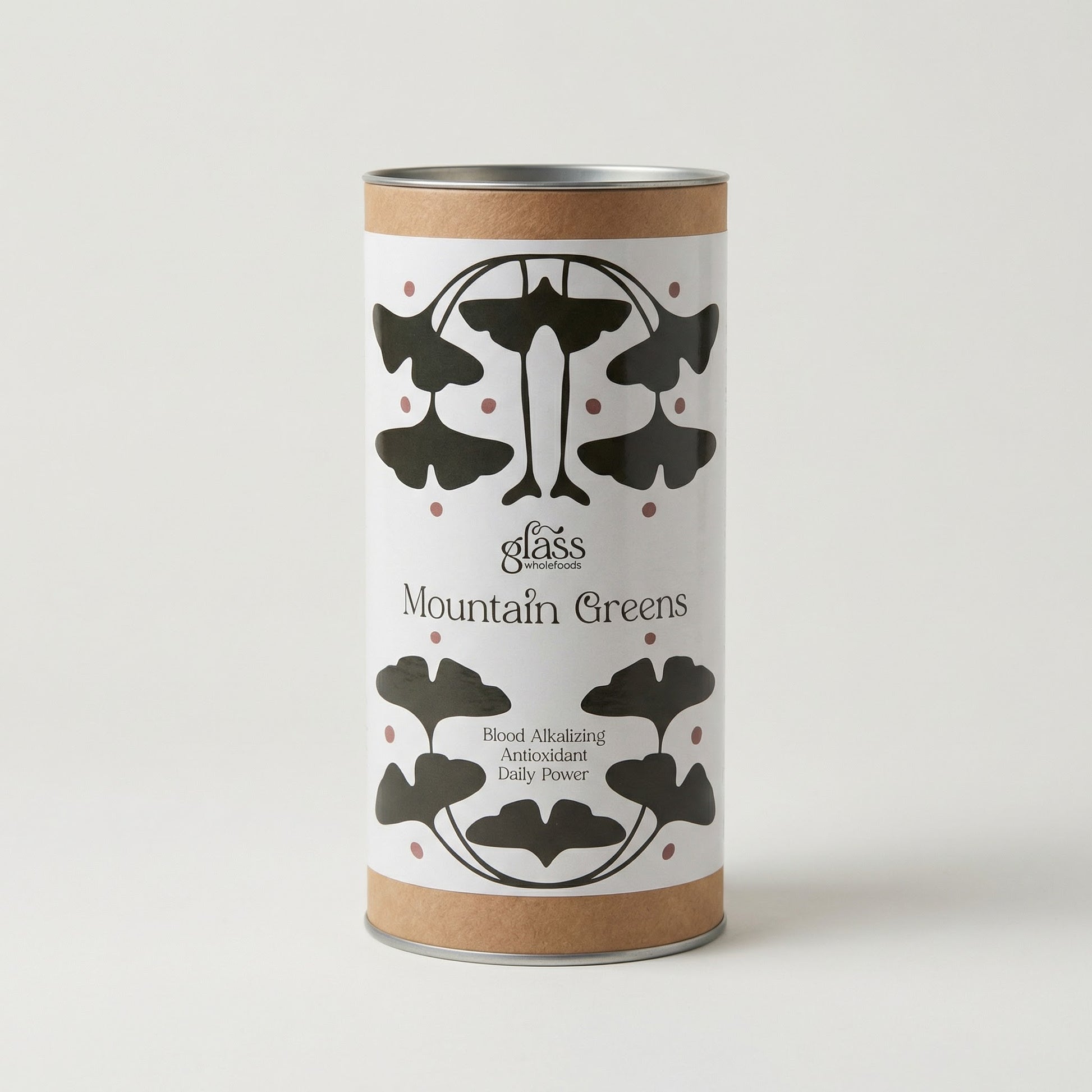 Glass Wholefoods Mountain Greens Daily Blend canister with ginkgo leaf design on white background